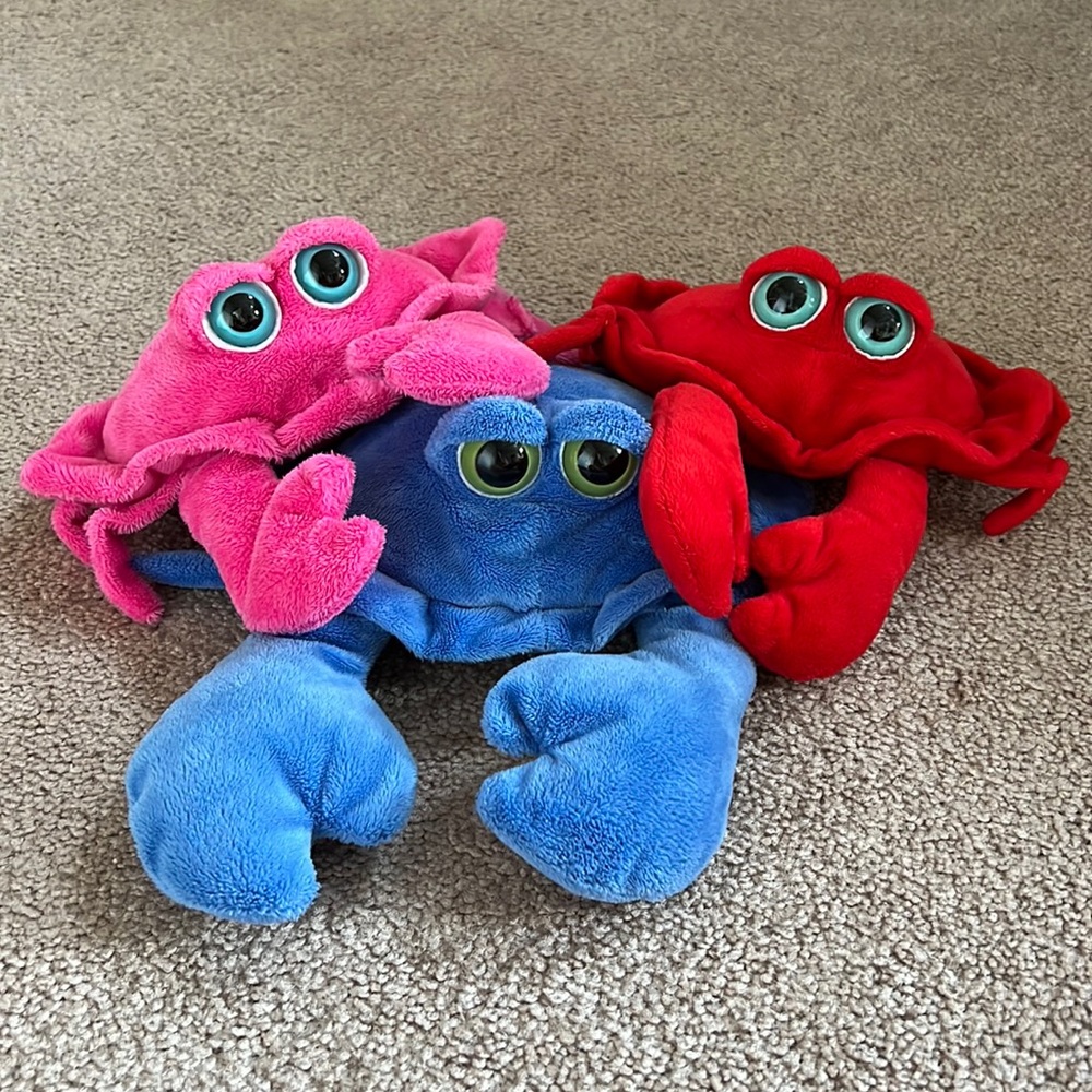 One blue, one red, and one pink Baltimore crab.